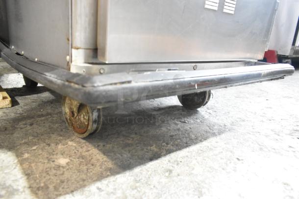Alto Shaam 1000-TH-I stainless steel Cook N Hold oven on commercial casters, showing wheel detail.