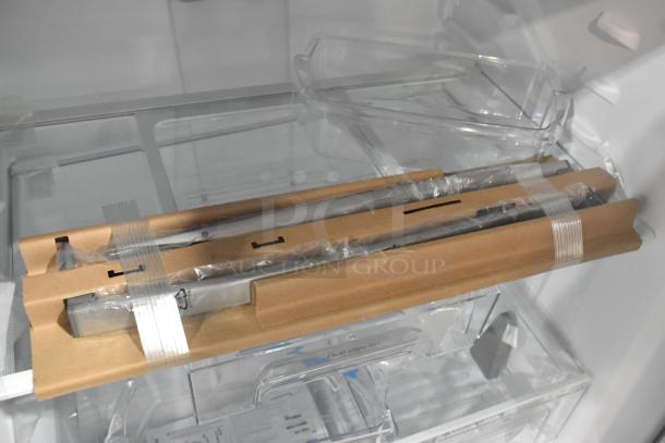 2025 Whirlpool WRT311FZDM05 stainless steel cooler interior, with new parts still in protective packaging; labeled "Flexi-Slide Bin."
