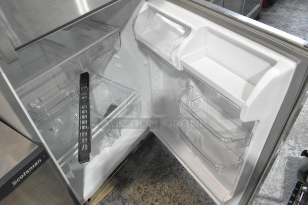 Brand new Whirlpool WRT311FZDM05 stainless steel commercial cooler with freezer, 115V, visible interior, shelves, and door bins.