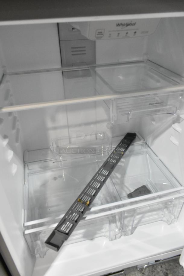 Brand new 2025 Whirlpool WRT311FZDM05 stainless steel cooler/freezer, 115 volts, 1 phase, minor scratches, interior view.