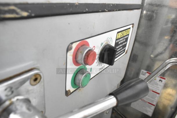 Centaur commercial planetary mixer control panel with timer and caution label. Features start/stop buttons and voltage details.