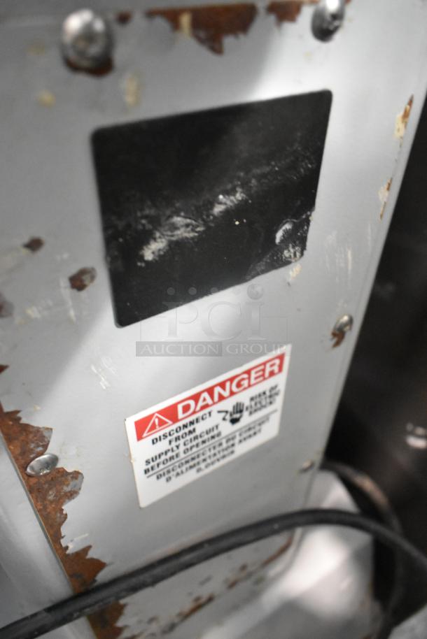 Centaur metal commercial floor mixer with metal bowl and whisk. Visible wear and rust; 208V, 1-phase power. Warning label shown.