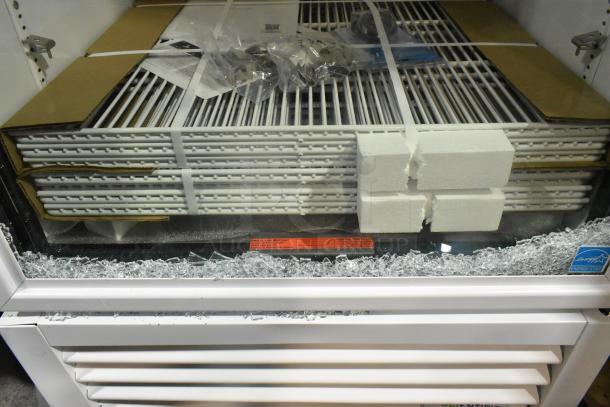 Brand new True TSCI-600R-G-PH cooler with broken glass, poly-coated racks, 115 volts, 1 phase. Scratch and dent condition.