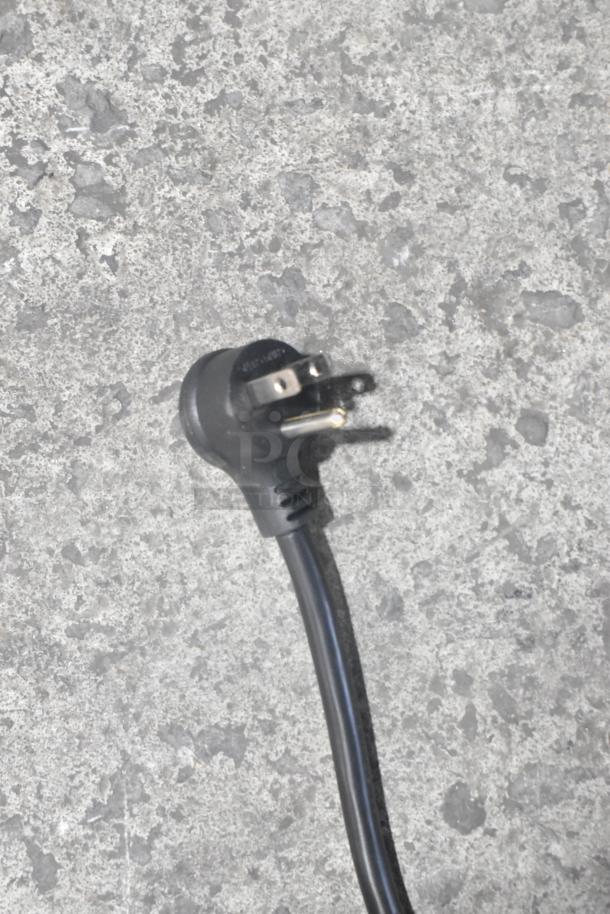 Alt text: Close-up of a power plug from a True TSCI-600R-G-PH cooler, 115 Volts, 1 Phase.