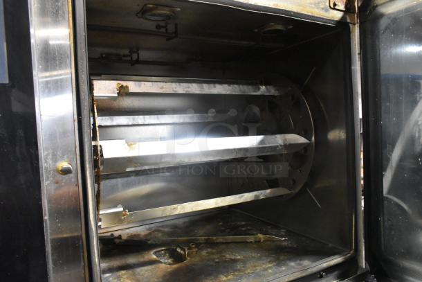 Stainless steel Alto Shaam AR-7T rotisserie oven interior with 7 spits, commercial use, self-cleaning feature.