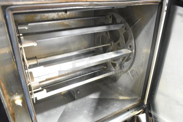 Alto Shaam AR-7T stainless steel rotisserie oven interior with seven spits, showing slightly used condition.