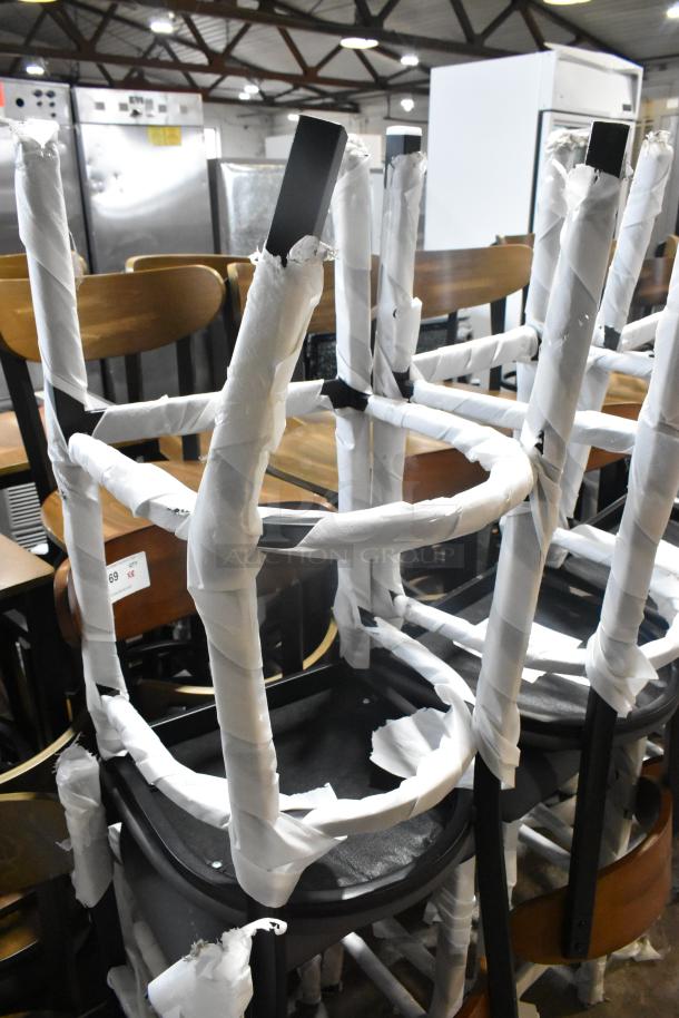 8 new bar height chairs, black metal, wooden backrest, gray cushion seat, wrapped for protection, minor scratches.