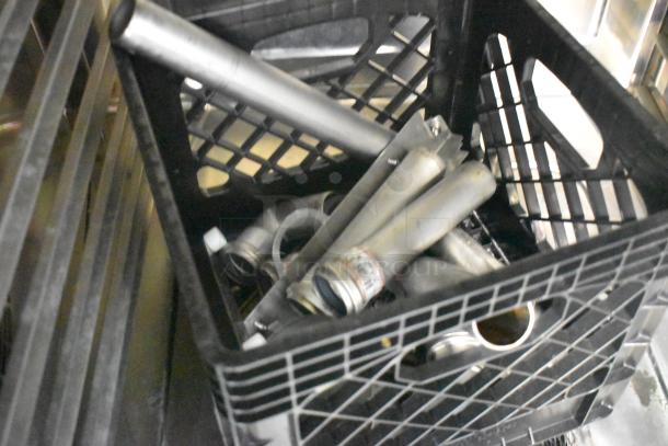 Stainless steel parts and pipes in a black crate, likely for a Rational iCombi Pro combi convection oven.