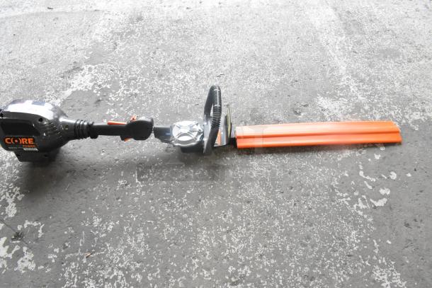 Core CHT410 Gasless Power Bush Trimmer, excellent condition, ergonomic handle, protective blade cover, Core branding visible.
