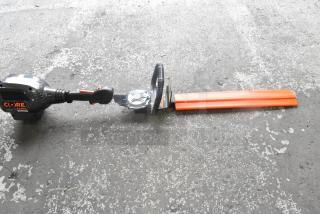 Core CHT410 Gasless Power Bush Trimmer, excellent condition, ergonomic handle, protective blade cover, Core branding visible.