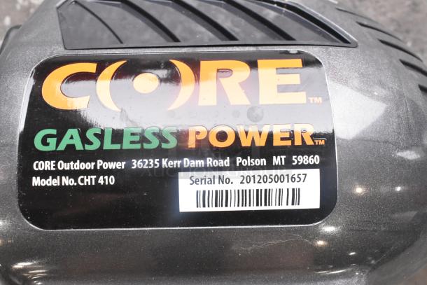 Core CHT410 Gasless Power Bush Trimmer, black casing with label showing model and serial number, by CORE Outdoor Power.