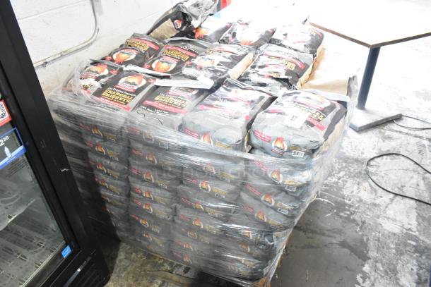 Stack of 120 sealed bags of Cooks Charcoal Briquets on a pallet, labeled for auction, pristine condition.