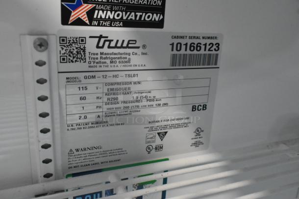 2021 True GDM-12-HC cooler label detailing model, 115 volts, refrigerant type R290. Poly coated racks, serial 10166123.