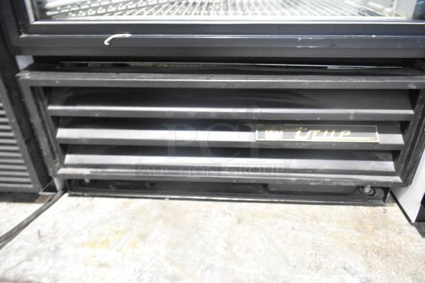 2021 True GDM-12 single door cooler merchandiser, metal body, poly coated racks, 115V, 1 phase, True logo visible.
