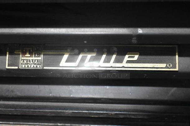 2021 True GDM-12 Cooler, single door, metal, poly coated racks, 115 volts, labeled "True Manufacturing Company."