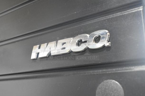 2019 Habco SE18 cooler logo on black metal panel, indicates model. Single door merchandiser with poly coated racks.
