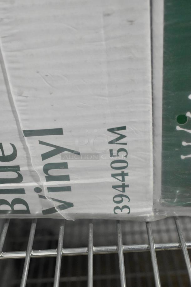 Two-tier lot featuring new Noble Products disposable gloves. Visible label: "Blue Vinyl" with model number 394405M.