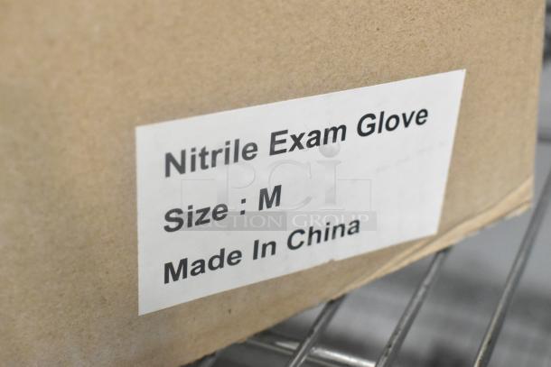 Box labeled "Nitrile Exam Glove, Size: M, Made in China" on a shelf. Part of a lot of brand new disposable gloves.