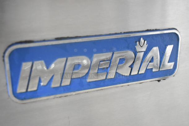 Imperial logo on stainless steel surface of commercial gas-powered griddle with 6 burners, convection, standard oven, shelf, backsplash.