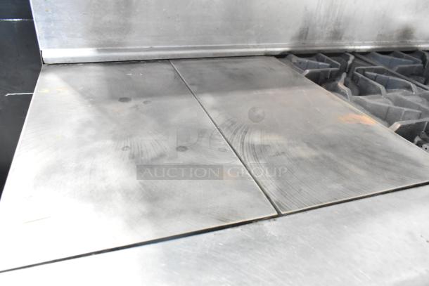 Imperial stainless steel commercial flat top griddle with 6 burner range, convection oven, standard oven, over shelf, and backsplash.