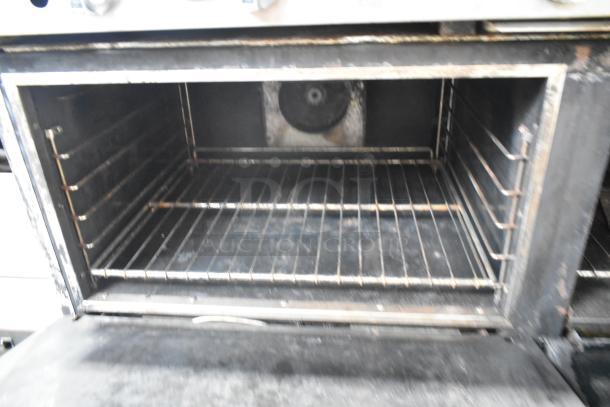 Imperial stainless steel commercial gas flat top griddle, includes 6 burners, convection oven, standard oven, overshelf, backsplash.