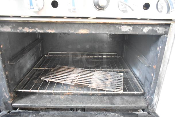 Imperial commercial oven interior showing grill rack. Notable wear and rust present on surfaces.