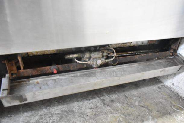 Imperial stainless steel commercial gas griddle, 6 burner range, convection and standard oven, with overshelf and backsplash.