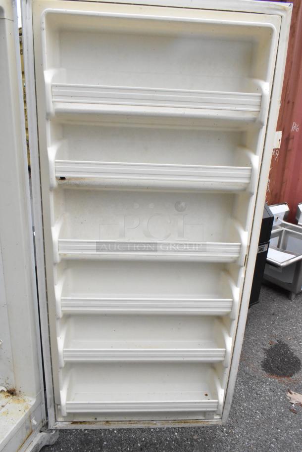 Frigidaire FFUH21F2NWA single door reach-in freezer interior, metal shelves, 115V, 1 phase, used condition.