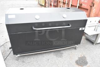 Backyard Pro metal commercial grill with casters, black finish, visible logo, sturdy handle, in used condition.