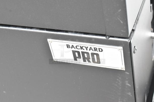 Backyard Pro metal commercial grill with casters, black finish, features manufacturer label on front panel.