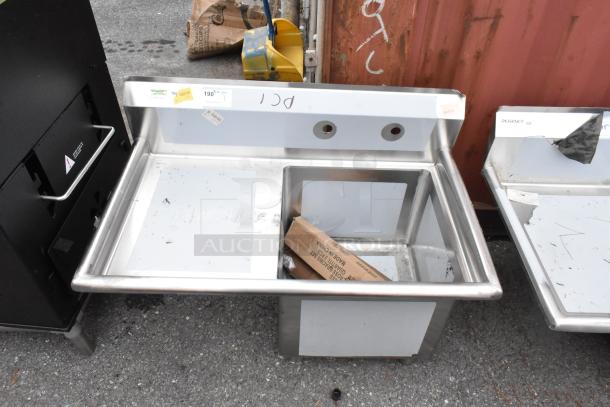 BRAND NEW scratch and dent Regency 600S1181818L stainless steel single bay sink with left side drain board, visible markings.