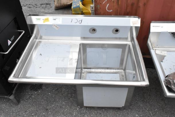Brand new Regency 600S1181818L stainless steel single bay sink, left drain board, visible dents, with NSF label.