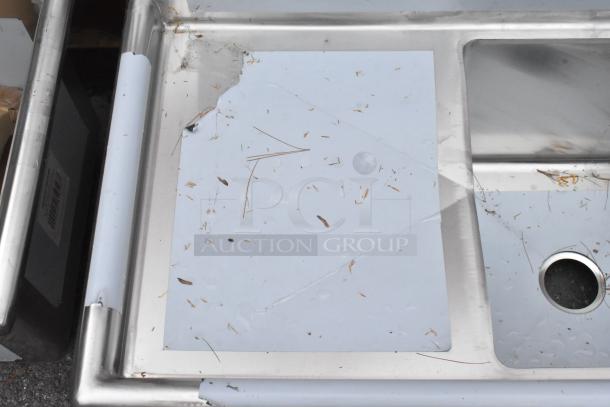 Regency 600S21818218 Stainless Steel 2 Bay Sink, scratch and dent, with dual drain boards, protective film partially removed.