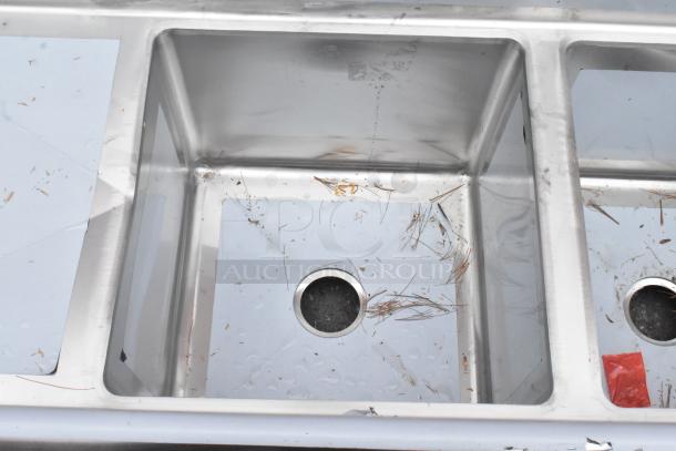 BRAND NEW SCRATCH AND DENT! Regency 600S21818218 stainless steel 2 bay sink with dual drain boards, minor scratches visible.