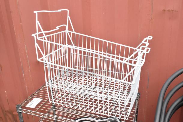Chrome finish 3-tier wire shelving unit with wire basket. Includes contents. Buyer must dismantle. Auction tag 194 visible.