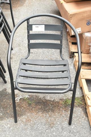 Black metal patio chair with armrests, slatted seat and back, in good condition. Label marked "195".