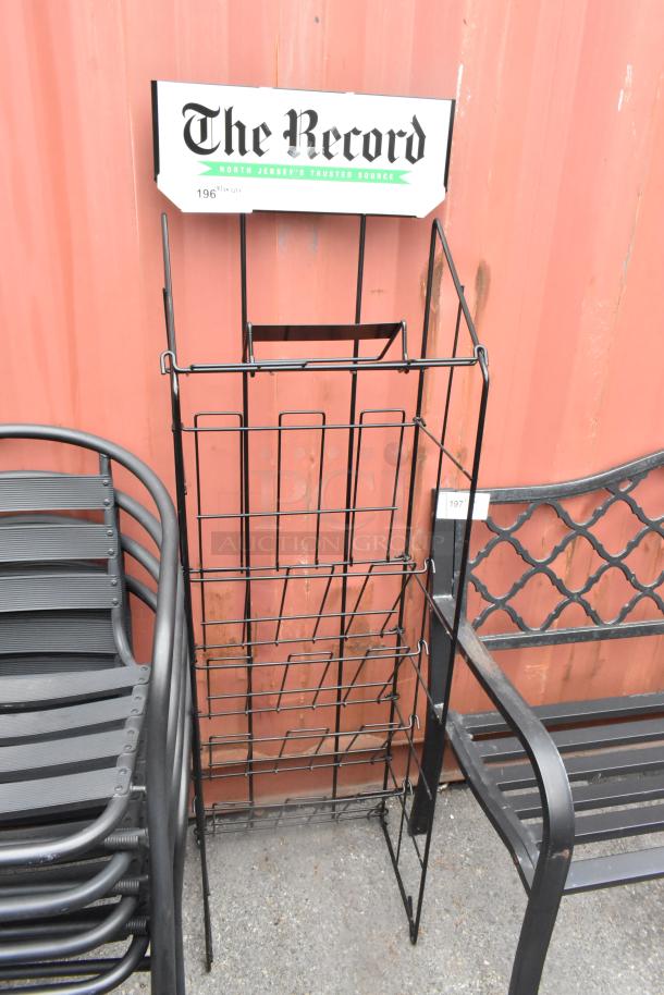 Black newspaper rack with grid design, featuring "The Record" label on top. Suitable for indoor/outdoor use. Good condition.