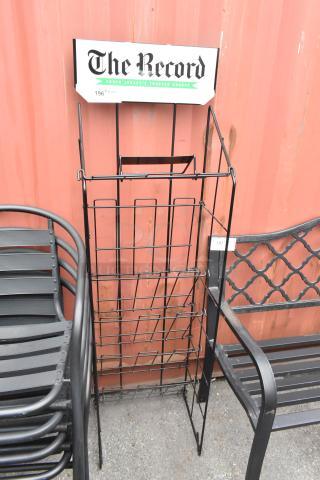 Black newspaper rack with grid design, featuring "The Record" label on top. Suitable for indoor/outdoor use. Good condition.