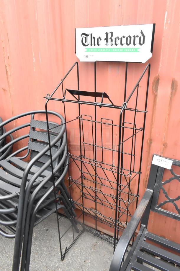 Black metal newspaper rack with "The Record" sign, used condition, suitable for displaying newspapers, approx. 4 feet tall.