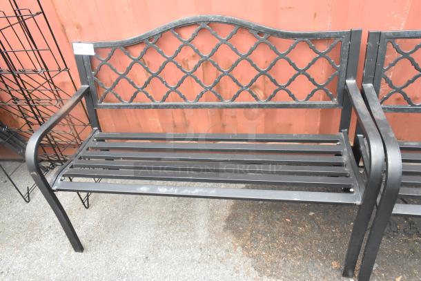 2 black metal benches with armrests, lattice back design, good condition, rust-resistant. Auction ID tag visible.