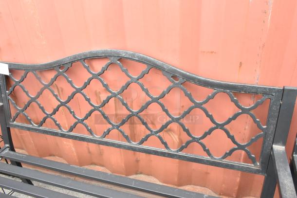 Two black metal benches with armrests, featuring a decorative lattice back. Sturdy, outdoor design. Auction for two.