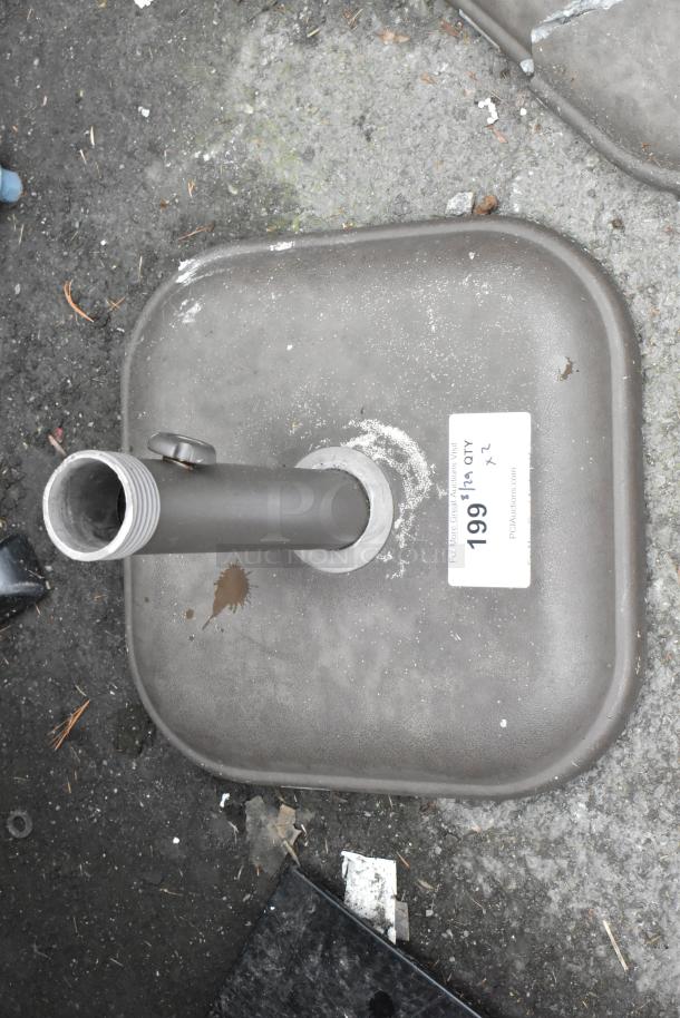 Square metal patio umbrella base with pole holder, some wear, auction item tag indicating "2 Times Your Bid."