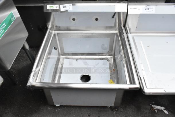 Brand new Regency 600S12323 stainless steel single bay sink, no legs, scratch and dent, NSF certified, tags visible.