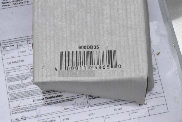 Barcoded box with number 600DB35 on top of shipping documents, showing pallet details and date.