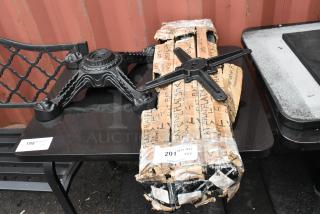 Five table base parts including a foot, top, and three columns. Condition varies, with one wrapped in branded packaging.