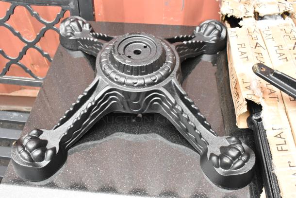 Black ornate cast iron table base foot with decorative claw feet, shown on a black surface, part of 5 table base components set.