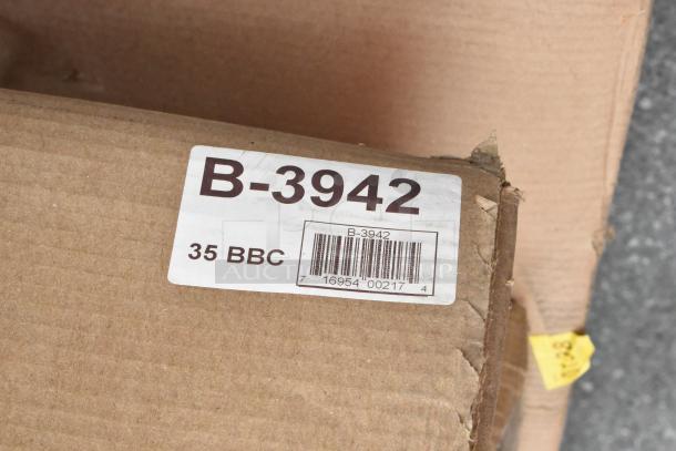 Cardboard box labeled "B-3942" for Bobrick ClassicSeries Paper Towel Dispenser/Trash Can, slightly damaged corner.