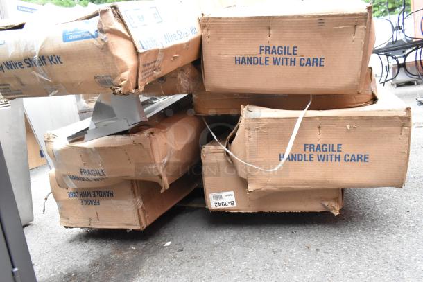 Boxes of 8 new, scratch and dent items; includes Bobrick B-3942 dispensers and 465C1872KE5 Steelton shelf kits. "Fragile" labels visible.