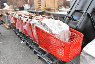 12 red metal shopping carts with bubble wrap, scratch and dent condition, on commercial casters.