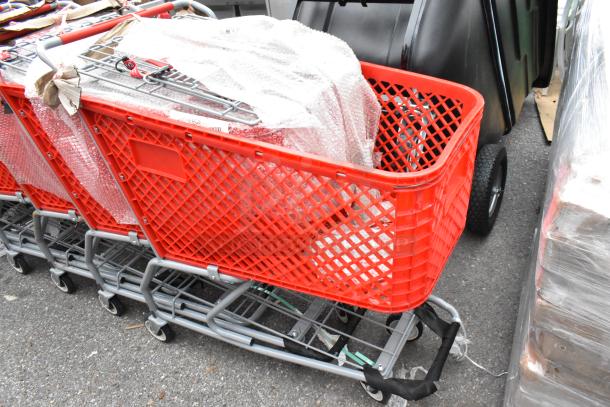 12 new red metal shopping carts, some with minor scratches and dents, on durable commercial casters. Packed in bubble wrap.
